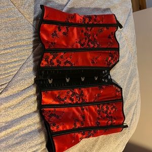 Red Corset with black flowers embroidered.